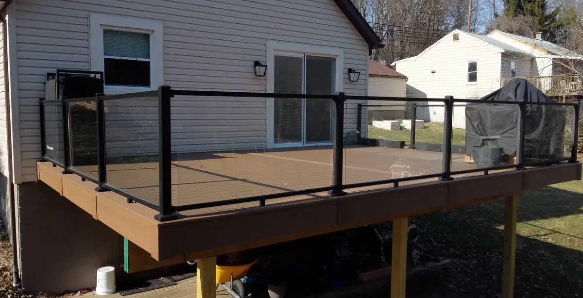 Brown composite deck with black glass-panel railing