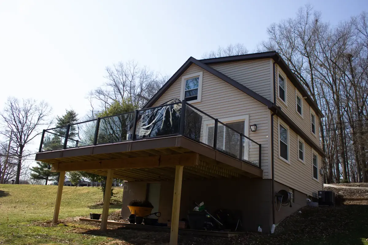 Elevated composite deck with frameless glass railing
